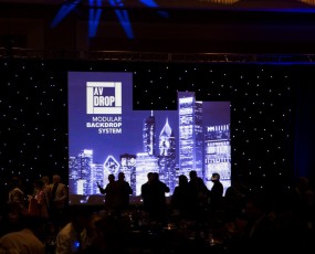 Cityscape AV-Drop Modular Backdrop covered in white fabric for front projection for corporate event