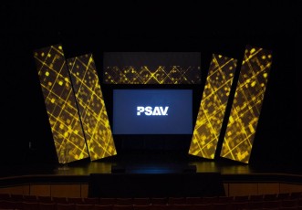 Angled AV-Drop Modular backdrop walls wrapped in white fabric for corporate stage event with front projection screen