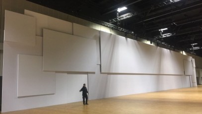 Multiple screens layered on AV-Drop Modular Backdrop white wall shown pre event