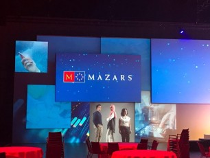 Multiple screens layered on AV-Drop Modular Backdrop white wall shown pre event